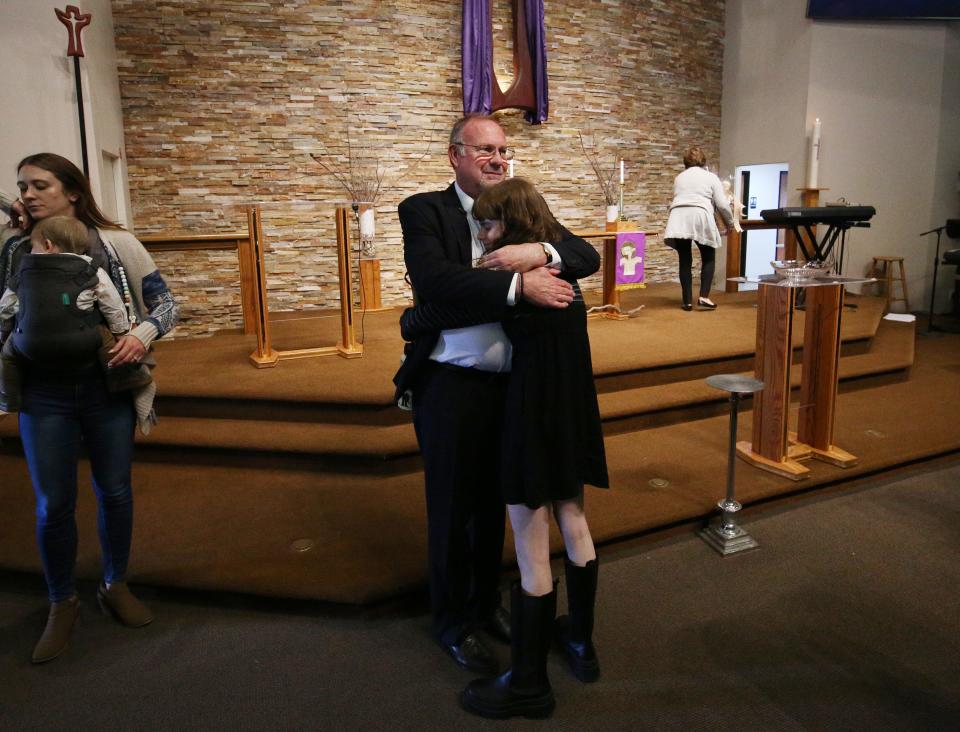 Pastor Brian Malison gets a hug from Trystin Zisko after service and is retiring after 35 years as pastor of Christ Lutheran Church, while being a community leader and an influential pastor in Visalia, Calif., Sunday, Feb. 26, 2023.