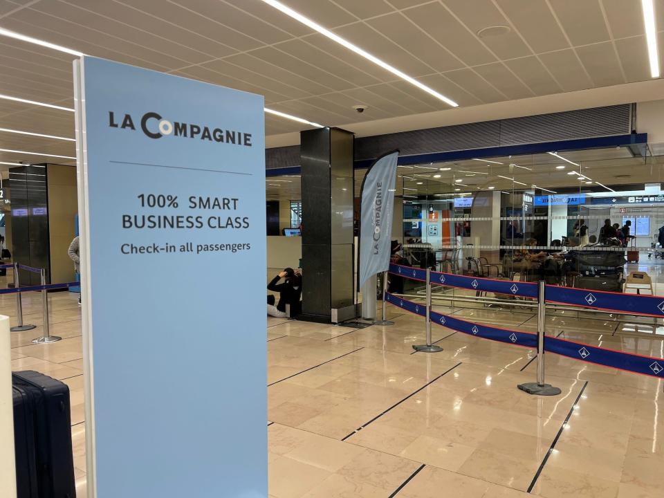 The check-in counter at Orly Airport's Terminal 4 with a sign for La Compagnie's "100% smart business class."