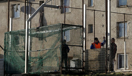 Roma men stand on a playground near the so called "Sheffield Square" in the town of Bystrany, Slovakia, November 28, 2016. REUTERS/David W Cerny