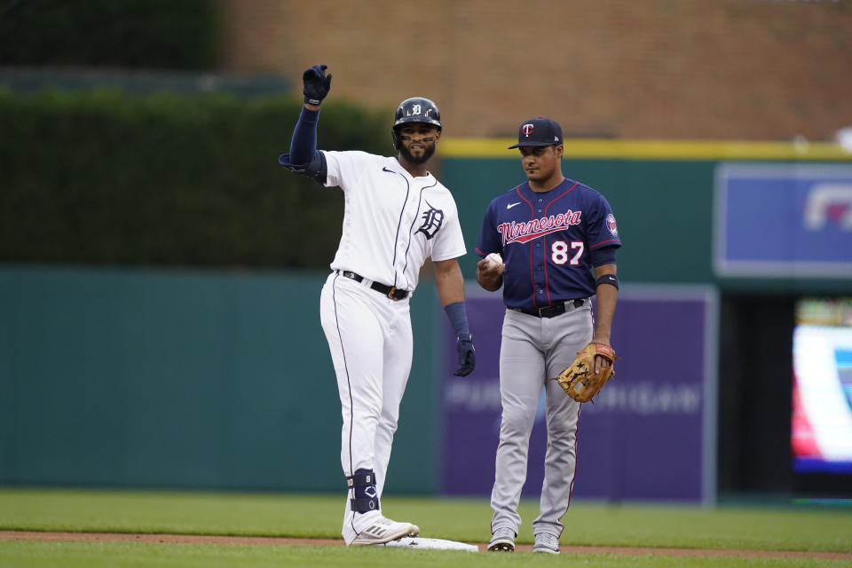 Detroit Tigers' Willi Castro, stand next to Minnesota Twins shortstop Jermaine Palacios (87), looks towards the dugout after his double during the first inning of a baseball game, Wednesday, June 1, 2022, in Detroit. (AP Photo/Carlos Osorio)