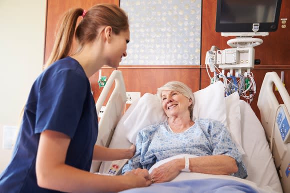 Nurse helping a patient.