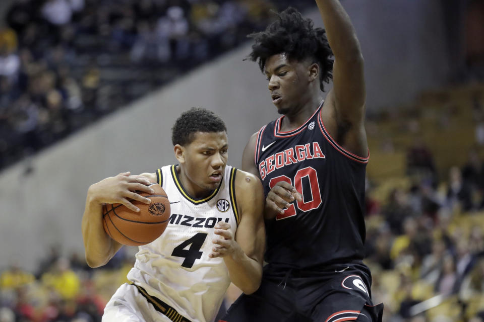 Missouri's Javon Pickett (4) heads to the basket past Georgia's Rayshaun Hammonds (20) during the second half of an NCAA college basketball game Tuesday, Jan. 28, 2020, in Columbia, Mo. Missouri won 72-69. (AP Photo/Jeff Roberson)