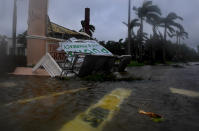 <p><strong>Estero</strong><br> A Subway sandwich shop sign is submerged (foreground) and a Publix grocery story sign is badly damaged in Estero, Florida after Hurricane Irma came through with the lead band of strength. (Photo: Michael S. Williamson/The Washington Post via Getty Images) </p>