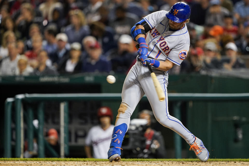 New York Mets' Jeff McNeil hits a two-RBI double during the sixth inning of a baseball game against the Washington Nationals at Nationals Park, Tuesday, May 10, 2022, in Washington. (AP Photo/Alex Brandon)