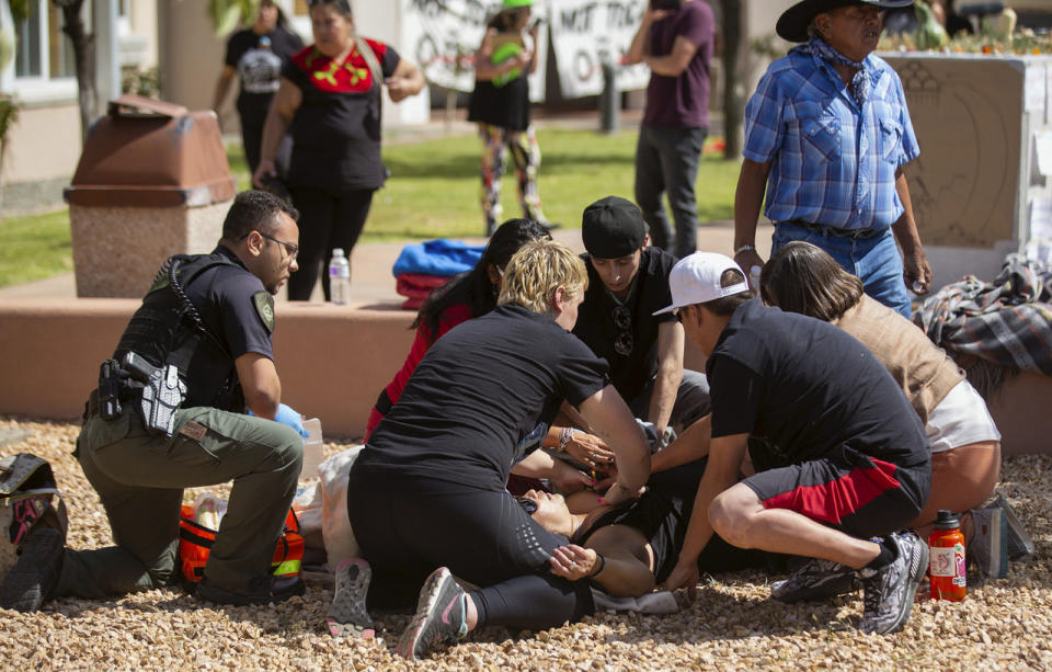 FILE - Activists tend to a shooting victim during a protest where officials had planned to install a statue of Spanish conquistador Juan de Oñate Thursday, Sept. 28, 2023, in Española, N.M. An appeals court on Monday, Nov. 20, has upheld a judge’s decision to deny bail to Ryan David Martinez, of New Mexico man, who is charged with attempted murder in the September shooting of a Native American activist during confrontations about canceled plans to reinstall a statue of a Spanish conquistador. Martinez has pleaded not guilty to the charges in the shooting at the protest. (Luis Sanchez Saturno/Santa Fe New Mexican via AP)