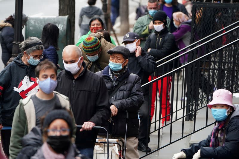 FILE PHOTO: People wait in line at the St. Clements Food Pantry in the Manhattan borough of New York City