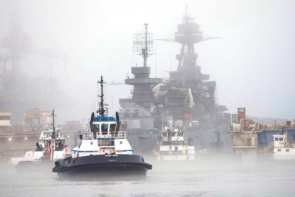 Tugboats guide Battleship Texas out of a drydock on Tuesday, March 5, 2024 in Galveston.