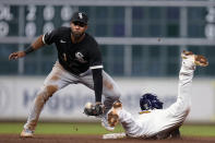 Houston Astros' Kyle Tucker, right, steals second as Chicago White Sox second baseman Elvis Andrus tries to catch the throw during the eighth inning of a baseball game Friday, March 31, 2023, in Houston. (AP Photo/Eric Christian Smith)