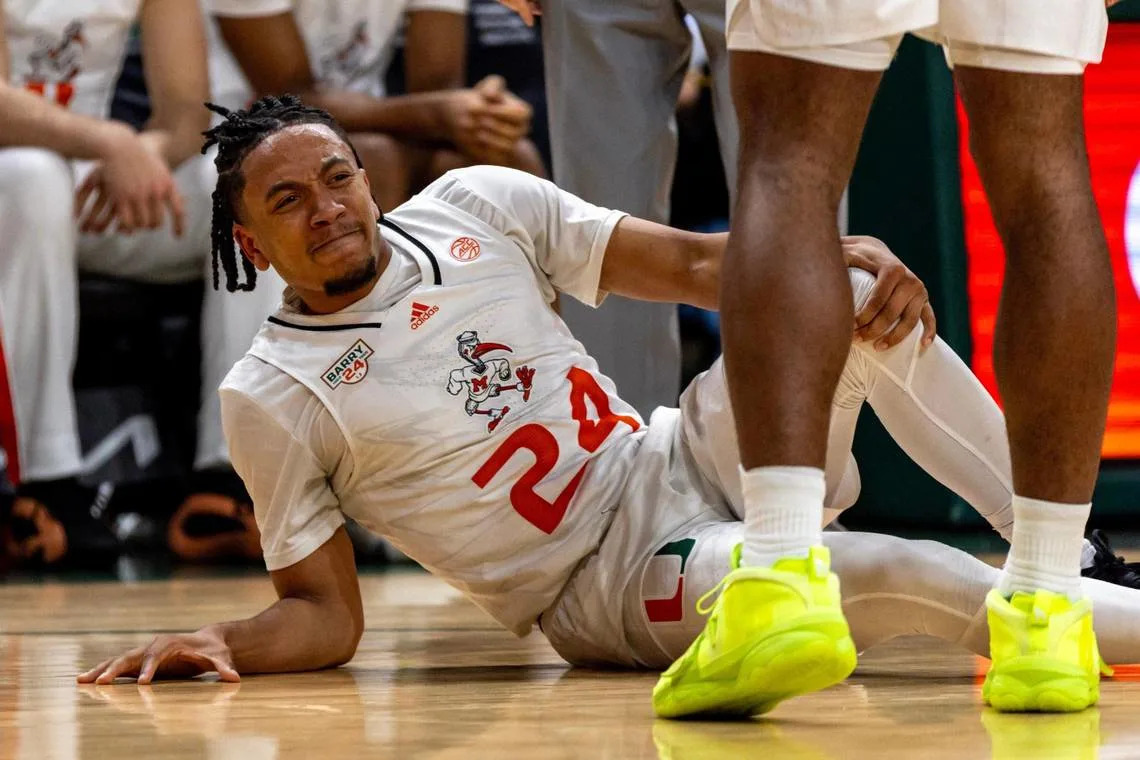 Hurricanes guard Nijel Pack (24) reacts to hurting his knee during the first half of an NCAA basketball game against Boston College at Watsco Center in Coral Gables, Florida on Wednesday, March 6, 2024. D.A. Varela/dvarela@miamiherald.com