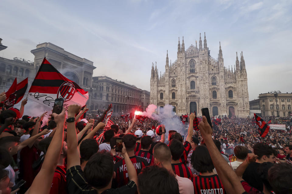 AC Milan fans celebrate in Piazza Duomo square after a Serie A soccer match between Sassuolo and AC Milan, being played in Reggio Emilia, in Milan, Italy, Sunday, May 22, 2022. AC Milan secured its first Serie A title in 11 years on Sunday with a 3-0 win at Sassuolo. (Alessandro Bremec/LaPresse via AP)