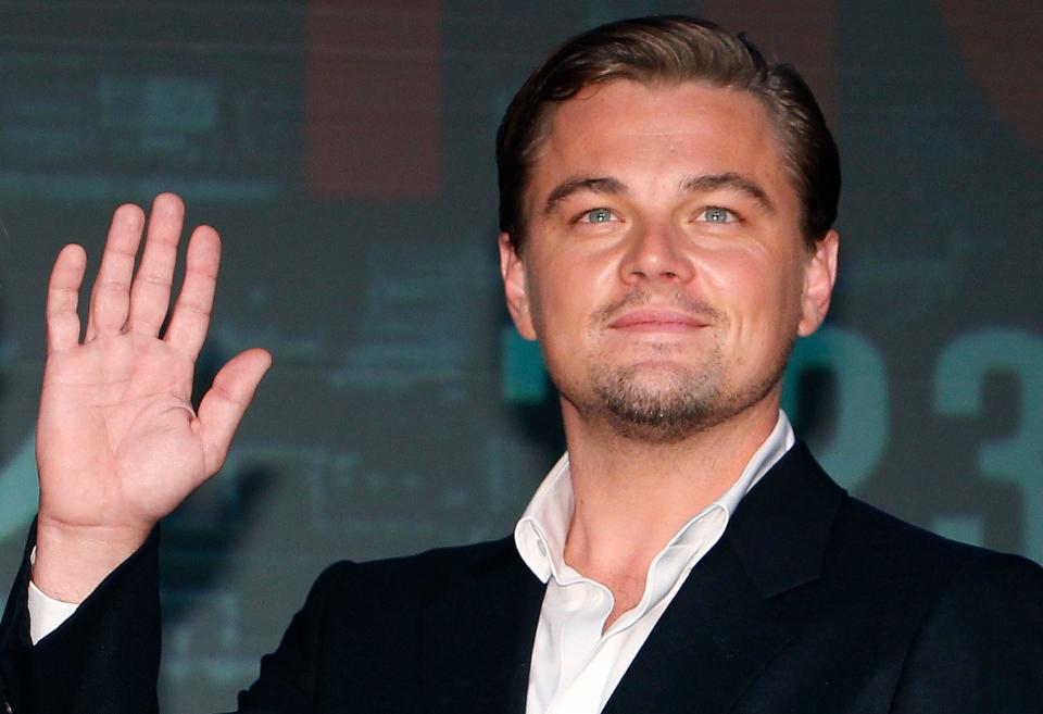 Actor Leonardo DiCaprio waves for photographers during a press conference of 