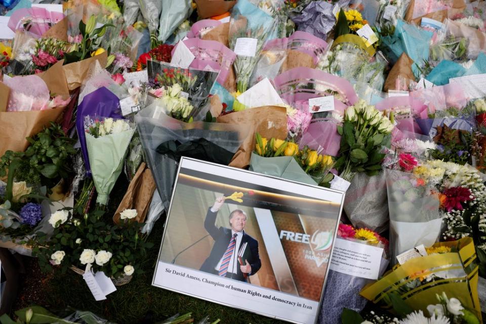 Floral tributes are left in Parliament Square for Sir David Amess MP (AFP via Getty Images)