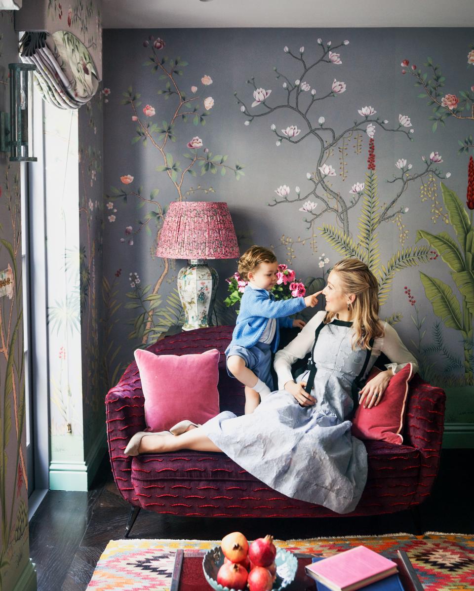 Gurney, wearing an Erdem dress, and George play on a settee sheathed in a Dedar jacquard velvet.