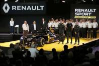 Renault Chief Executive Carlos Ghosn (2ndL), Renault Formula One racing driver Kevin Magnussen of Denmark (R) and teammate Jolyon Palmer of Britain (C) unveil the new Renault RS16 car during its official presentation at the company's research center, the Technocentre, in Guyancourt, near Paris, France, February 3, 2016. REUTERS/Benoit Tessier