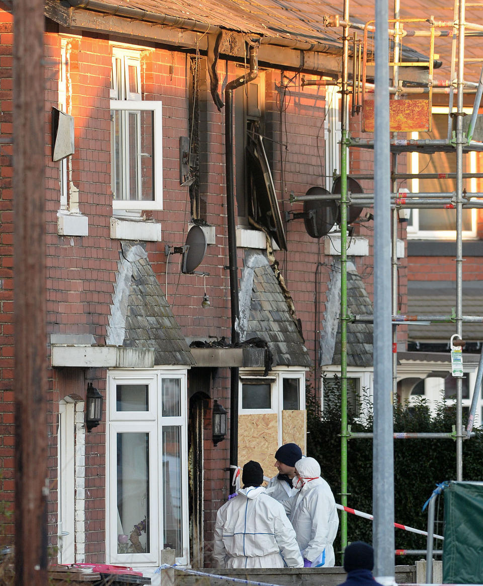 <em>Forensic officers at the scene of the house fire in Manchester in December (PA)</em>