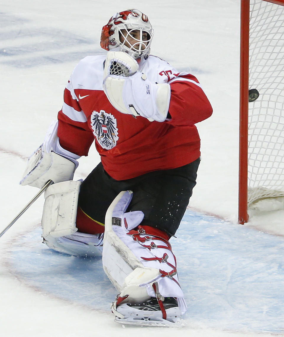 Austria goaltender Bernhard Starkbaum looks back as the puck hits the net for a goal by Finland in the first period of a men's ice hockey game at the 2014 Winter Olympics, Thursday, Feb. 13, 2014, in Sochi, Russia. (AP Photo/Mark Humphrey)