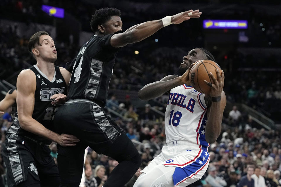 Philadelphia 76ers guard Shake Milton (18) looks to shoot as he is defended by San Antonio Spurs guard Blake Wesley (14) during the first half of an NBA basketball game in San Antonio, Friday, Feb. 3, 2023. (AP Photo/Eric Gay)