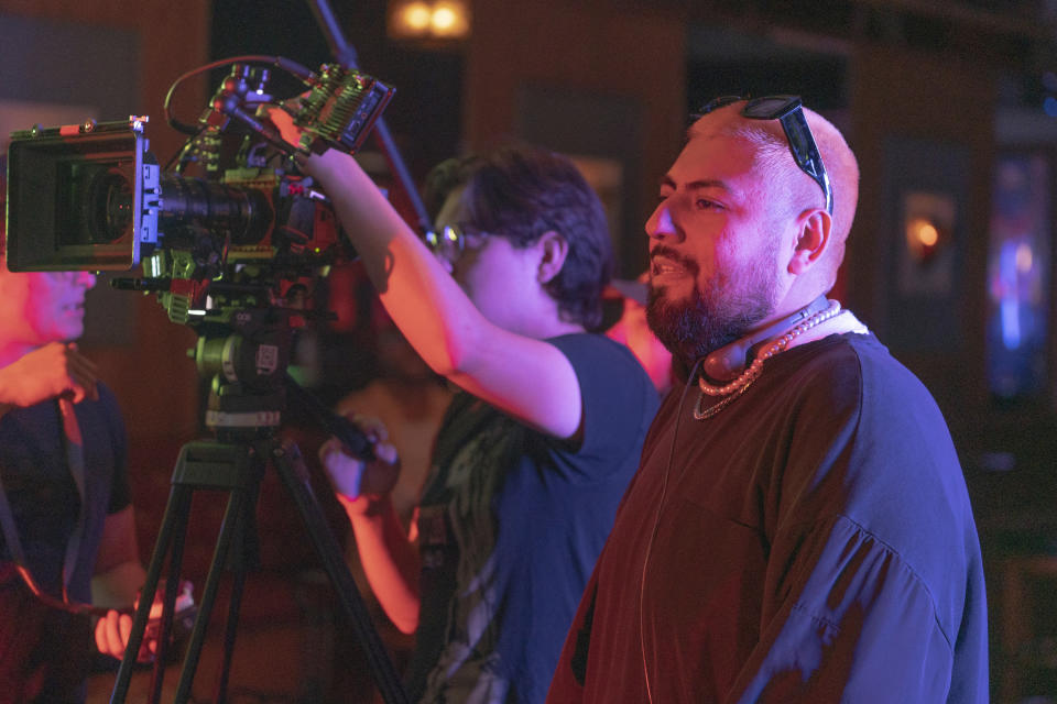 Jorge Xolalpa, a 33-year-old movie director from Mexico, films his latest movie, "Union Station," at "Trunks," a gay sports bar in West Hollywood, Calif., on Tuesday, Oct. 4, 2022. Xolalpa is mired in a years-long battle over whether he can keep working legally in the United States. He is among hundreds of thousands of people waiting to learn if the program known as Deferred Action for Childhood Arrivals will be allowed to continue. (AP Photo/Damian Dovarganes)