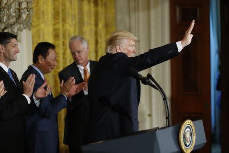 U.S. President Donald Trump (R) is applauded by House Speaker Paul Ryan (R-WI) (L), Foxconn Chairman Terry Gou (2ndL) and Senator Ron Johnson (R-WI) during a White House event where the Taiwanese electronics manufacturer announced plans to build a $10 billion dollar LCD display panel screen plant in Wisconsin, in Washington, U.S., July 26, 2017. REUTERS/Jonathan Ernst