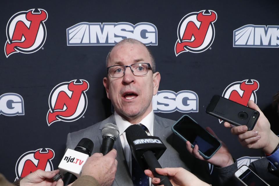 FILE - In this Feb. 16, 2020, file photo, New Jersey Devils interim general manager Tom Fitzgerald speaks to reporters in Newark, N.J. A person with knowledge of the talks tells The Associated Press that the New Jersey Devils are hiring veteran coach Lindy Ruff to take over one of the NHL’s youngest teams and removing the interim tag off Tom Fitzgerald’s title as general manager. (AP Photo/Kathy Willens, File)