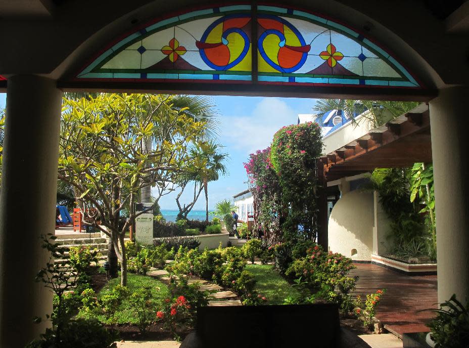 This November 2012 photo shows the view from inside the idyllic, Italian villa-styled Villa Rolandi hotel, which overlooks the bay off Isla Mujeres, Mexico. Isla Mujeres, or Island of Women, is a tiny 5-mile-long, half-mile wide island just a half-hour's ferry ride across from Cancun, with far fewer visitors and a much calmer, romantic atmosphere. (AP Photo/Amanda Lee Myers)