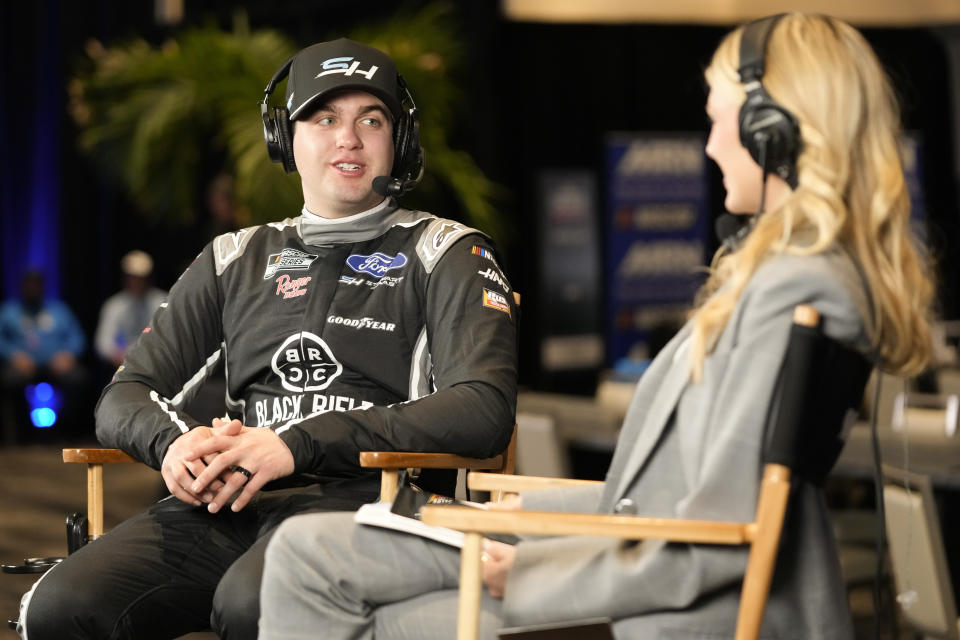 Noah Gragson, left, takes part in an interview at NASCAR Daytona 500 auto racing media day at Daytona International Speedway, Wednesday, Feb. 14, 2024, in Daytona Beach, Fla. (AP Photo/John Raoux)