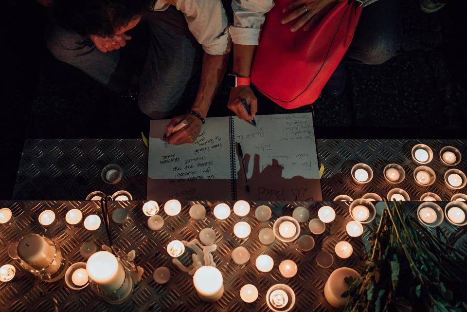 <p>People in Hong Kong take part in a candlelight vigil for the victims of the Orlando massacre, June 13, 2016, in Hong Kong. The vigil was organized by Betty Grisoni, co-director of Pink Dot and co-founder of local lesbian group Les Peches. (Anthony Kwan/Getty Images) </p>