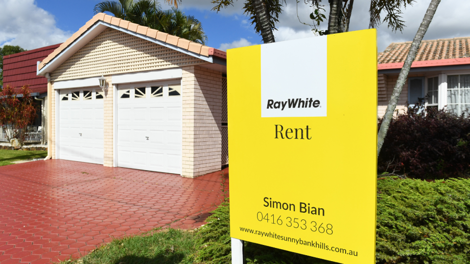 A home in Queensland with a sign out the front indicating it is for rent.