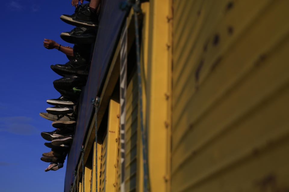 FILE - In this Oct. 29, 2018 file photo, members of a Central American migrant caravan get a free ride on a truck near Tapanatepec, Mexico. The Mexican government says around 3,000 migrants have applied for refuge in Mexico in recent weeks and about 500 have asked for assistance to return to their countries of origin. (AP Photo/Rebecca Blackwell, File)