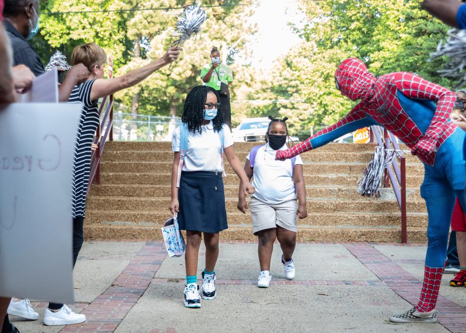 Douglass K-8 Optional School students head to class for their first day of school on Monday, Aug. 9, 2021. Schools have begun reopening leaving it up to local schools to decide whether to require masks.