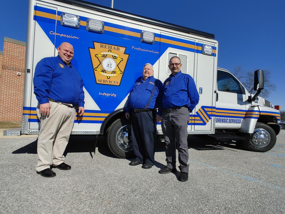 Franklin County Coroner Jeff Conner, center, stands with deputy coroners Jordan Conner, left, and Ted Reed, right, outside of the office's rehab unit.