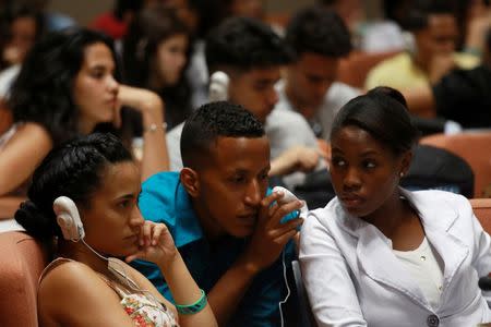 Design students listen to Martin Sorrell (not pictured), British businessman and chief executive of the world's biggest advertising group WPP, performing a master class on the industry and how to develop it on the communist-run island during the First International Design Biennial of Havana, Cuba, May 20, 2016. REUTERS/Alexandre Meneghini