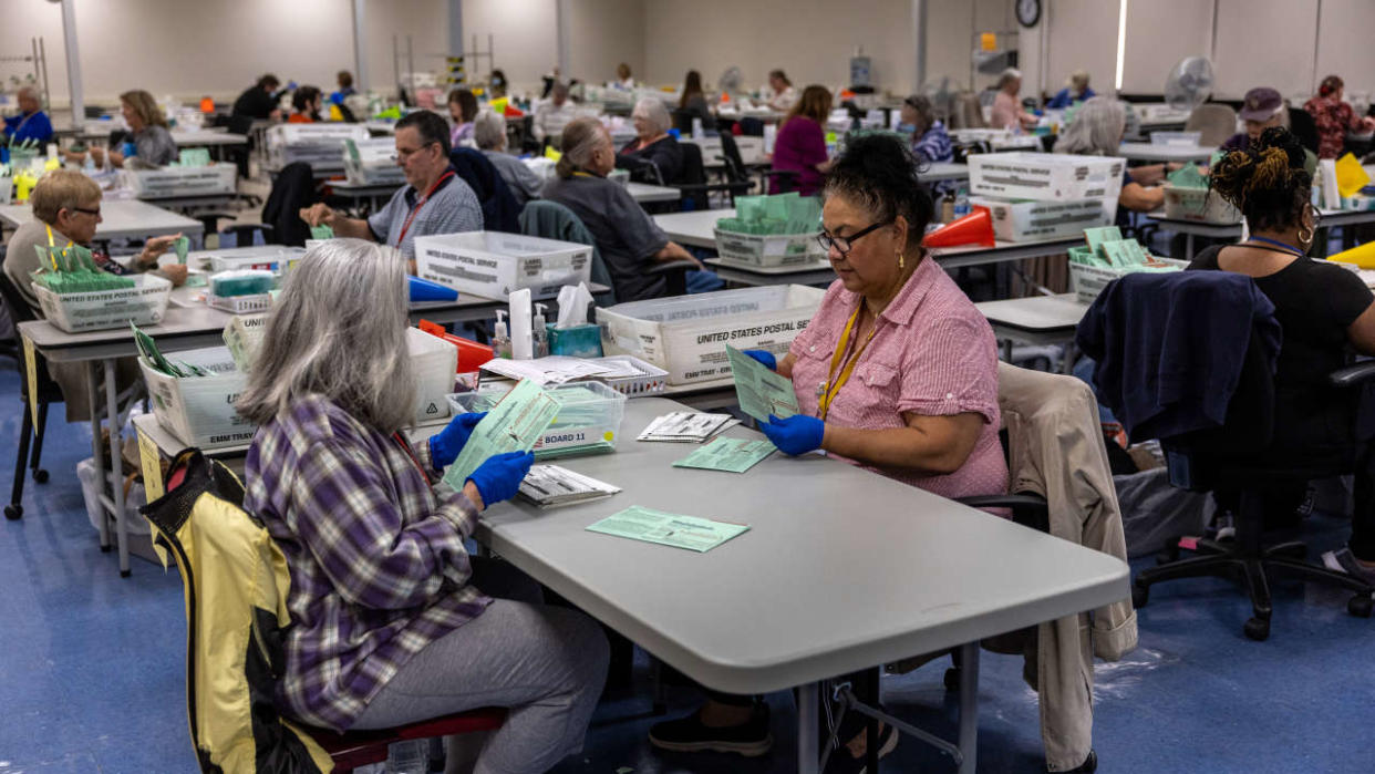 PHOENIX, ARIZONA - NOVEMBER 09:  Election workers sort ballots at the Maricopa County Tabulation and Election Center on November 09, 2022 in Phoenix, Arizona. A day after midterm elections Arizona election officials continue counting votes in close state races. (Photo by John Moore/Getty Images)