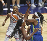 Minnesota Lynx center Sylvia Fowles, right, loses the ball under pressure from Connecticut Sun forward Jonquel Jones, front left, during a WNBA basketball game Sunday, Aug. 14, 2022, in Uncasville, Conn. (Sean D. Elliot/The Day via AP)