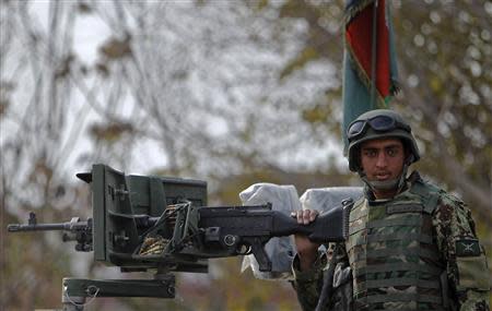 An Afghan National Army (ANA) soldier keeps watch near a building in which the Loya Jirga (or grand council) is holding a committee session, in Kabul November 22, 2013. REUTERS/Omar Sobhani