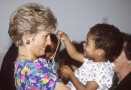 <p>Princess Diana, Princess of Wales, meets a smiling child on a visit to São Paulo, Brazil, on April 24, 1991. (Photo by Tim Graham/Getty Images) </p>