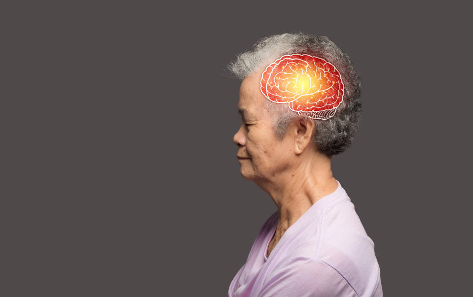 An elderly person is shown in profile with an illustration of a brain highlighted with red and yellow colors, indicating a focus on brain health or activity