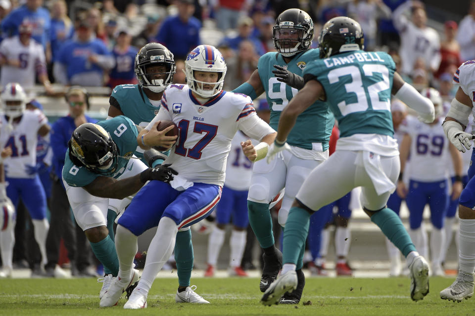 Buffalo Bills quarterback Josh Allen (17) is sacked by Jacksonville Jaguars defensive end Jihad Ward (6) and =cornerback Tyson Campbell (32) during the first half of an NFL football game, Sunday, Nov. 7, 2021, in Jacksonville, Fla. (AP Photo/Phelan M. Ebenhack)