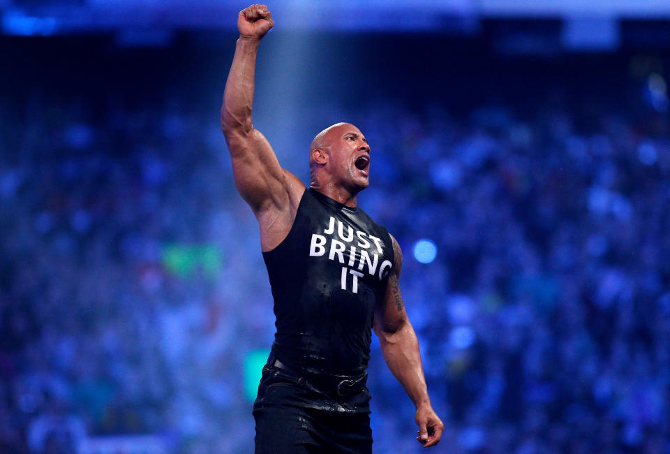 Dwayne Johnson aka The Rock reacts during Wrestlemania XXX at the Mercedes-Benz Super Dome in New Orleans on Sunday, April 6, 2014. (Jonathan Bachman/AP Images for WWE)