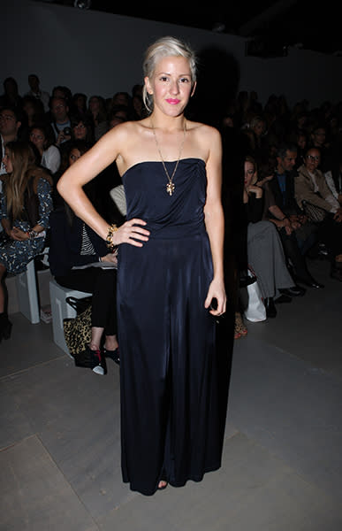 <div class="caption-credit"> Photo by: Getty Images</div><div class="caption-title">In the front row at Marios Schwab's S/S 2012 show</div>This is a much more comfortable and relaxed look for Ellie. The maxi jumpsuit is not an easy wardrobe piece to pull off, but by keeping her accessories simple (a long gold necklace and a single bracelet) she nails it. Plus, the swipe of bright magenta lip color is the perfect accent to any otherwise monochrome look.