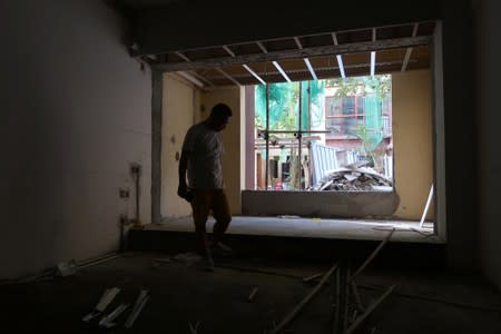 Ma Mao, 41, a businessman from Shanxi province, stands inside a room under decoration at one of his newly bought apartment buildings developed by Sunac China Holdings in Xishuangbanna, Yunnan