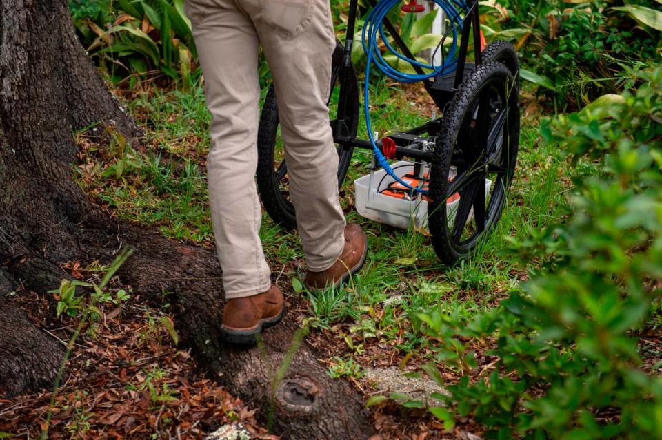 Clayton Fulgham pushes a radar that can penetrate the ground around the base of a live oak tree on a property in Ocean Springs on Thursday, May 26, 2022. The radar is used to map out tree root systems in order to help construction companies avoid disrupting the roots.