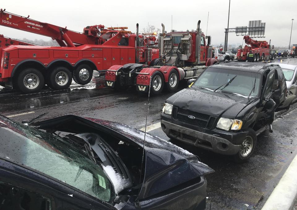 Tow trucks remove wrecked vehicles after a series of accidents on Interstate 95 in Baltimore, Md., on Saturday morning, Dec. 17, 2016, following an overnight ice storm. (Karl Merton Ferron/The Baltimore Sun via AP)