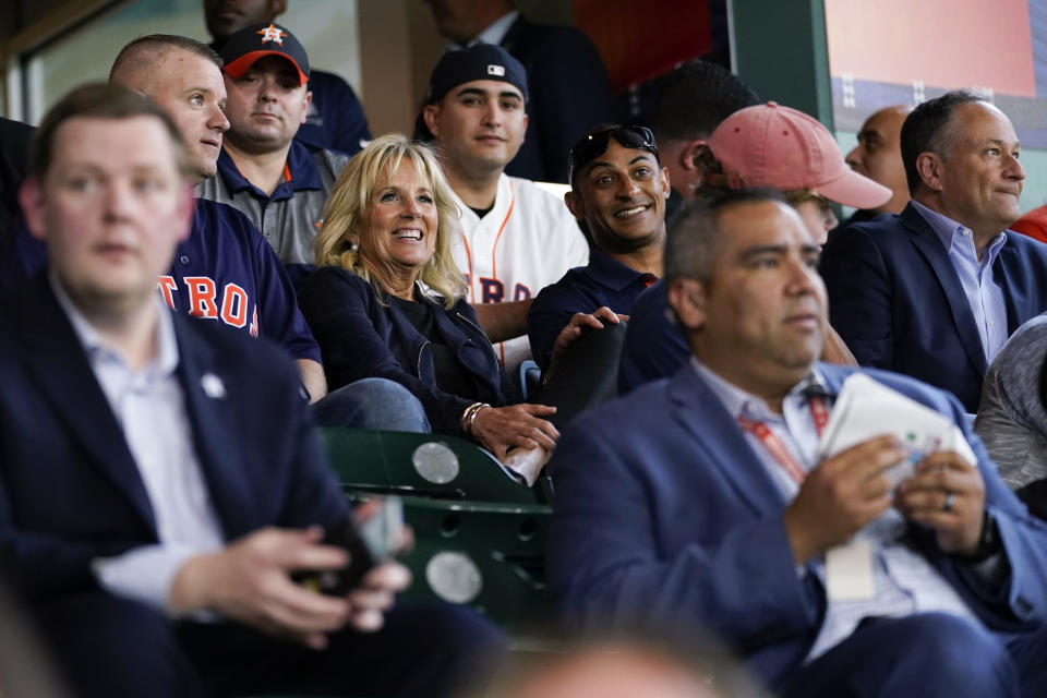 FILE - First lady Jill Biden and Doug Emhoff sit with military members and first responders as they attend a baseball game between the Houston Astros and the Baltimore Orioles at Minute Maid Park, in Houston, June 29, 2021. (AP Photo/Carolyn Kaster, Pool, File)