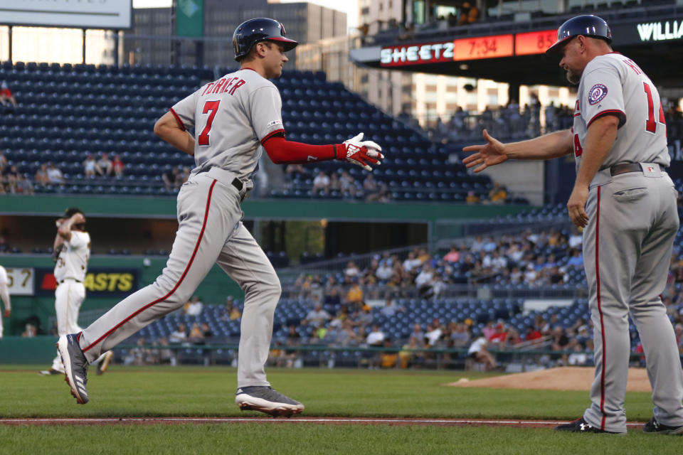 Washington Nationals' Trea Turner (7) is greeted by third base coach Bob Henley after hitting a three-run home run off Pittsburgh Pirates starting pitcher Trevor Williams, back left, in the second inning of a baseball game Monday, Aug. 19, 2019, in Pittsburgh. (AP Photo/Keith Srakocic)