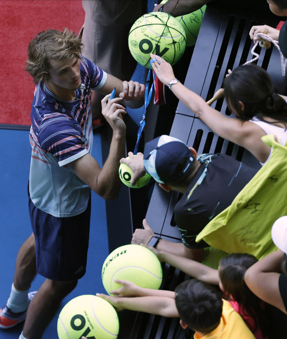 Germany's Alexander Zverev signs autographs after defeating Switzerland's Stan Wawrinka in their quarterfinal match at the Australian Open tennis championship in Melbourne, Australia, Wednesday, Jan. 29, 2020. (AP Photo/Dita Alangkara)