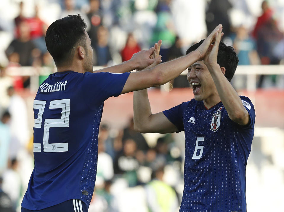 Japan's defender Maya Yoshida, left, and Japan's defender Wataru Endo celebrate after the AFC Asian Cup round of 16 soccer match between Japan and Saudi Arabia at the Sharjah Stadium in Sharjah, United Arab Emirates, Monday, Jan. 21, 2019. Japan won the match 1-0. (AP Photo/Hassan Ammar)