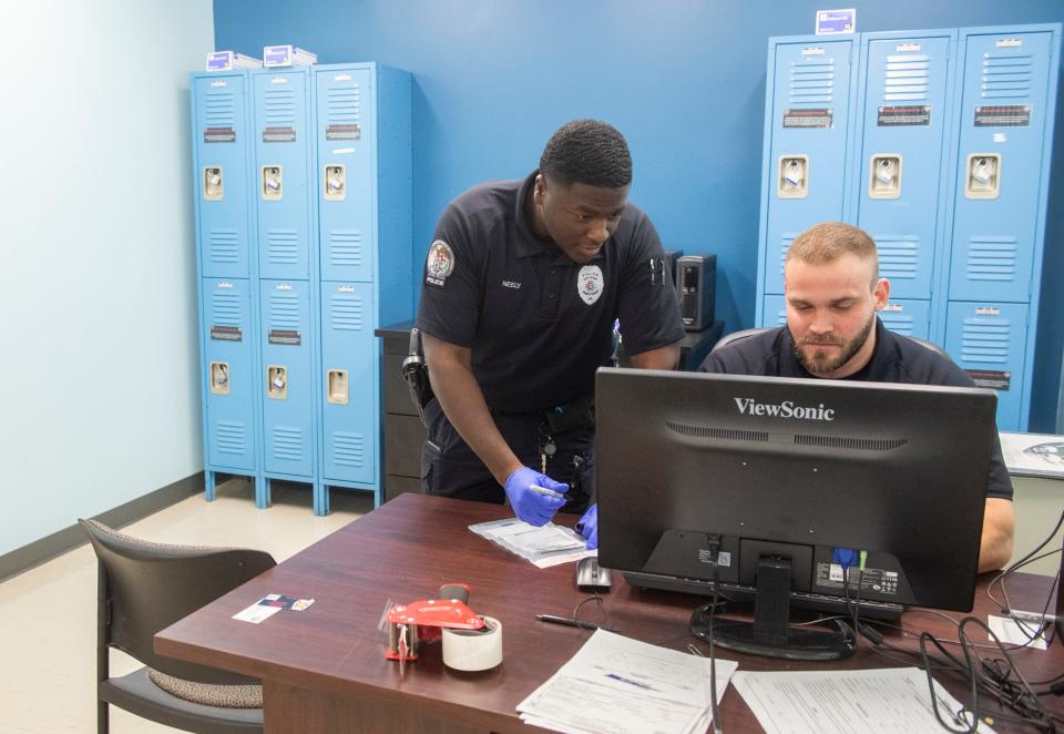 Newly hired Prattville Police officers Trey Neely, left, and Josiah Welch work at the Prattville Police Department in Prattville, Ala., on Tuesday, Nov. 14, 2023.