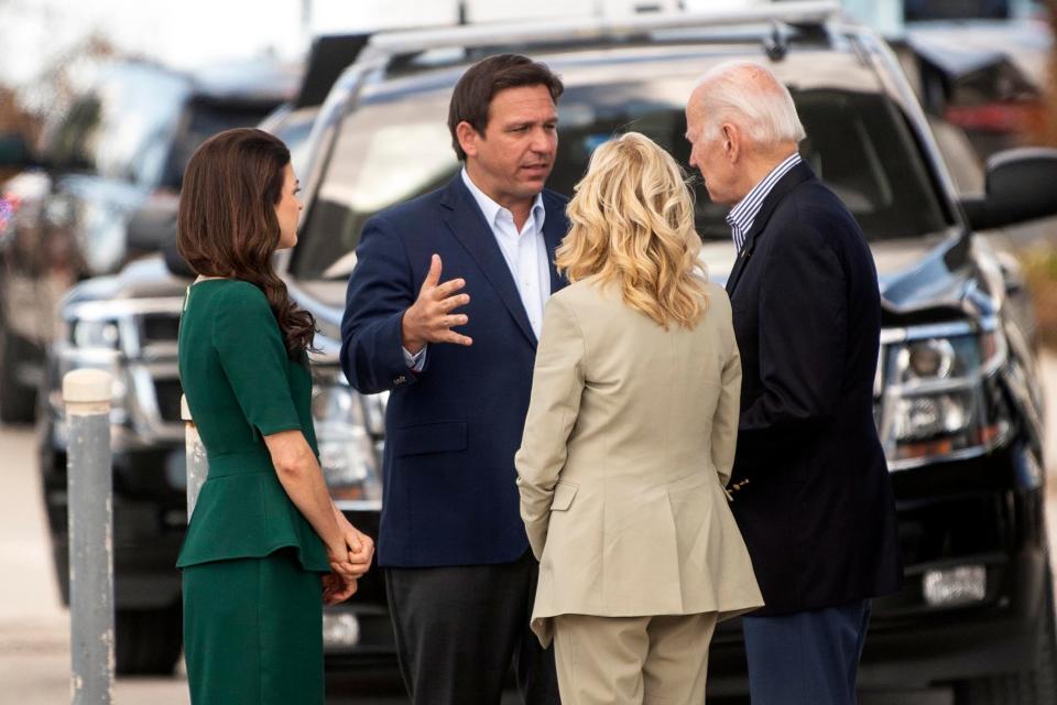Florida Gov. Ron DeSantis and Florida's first lady, Casey DeSantis, left, talk with President Joe Biden and first lady Jill Biden at Fort Myers Beach on Oct. 5, 2022.