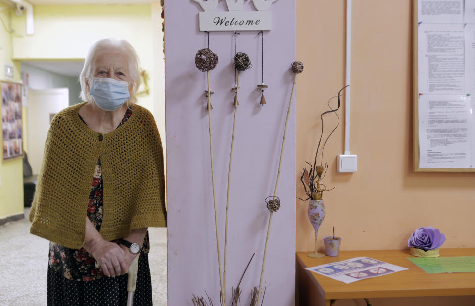 An elderly woman waits to receive a dose of the COVID-19 vaccine, at Nadezhda nursing home, in Sofia, Wednesday, Jan. 27, 2021. Bulgaria began vaccinating elderly people on Wednesday. (AP Photo/Valentina Petrova)